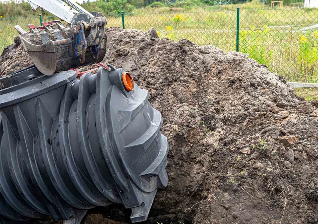 The installation of a sewage treatment plant in a home garden.