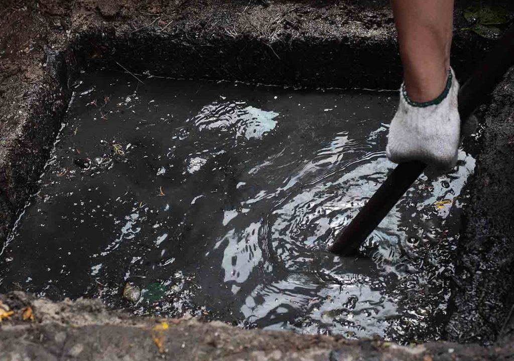 A flooding drain being fixed.