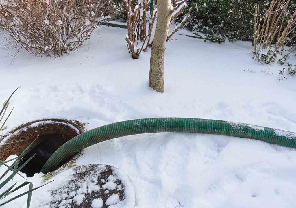 A tank being drained in the snow.