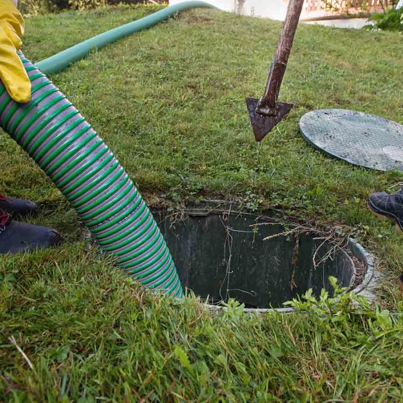 Emptying a septic tank with a pipe.