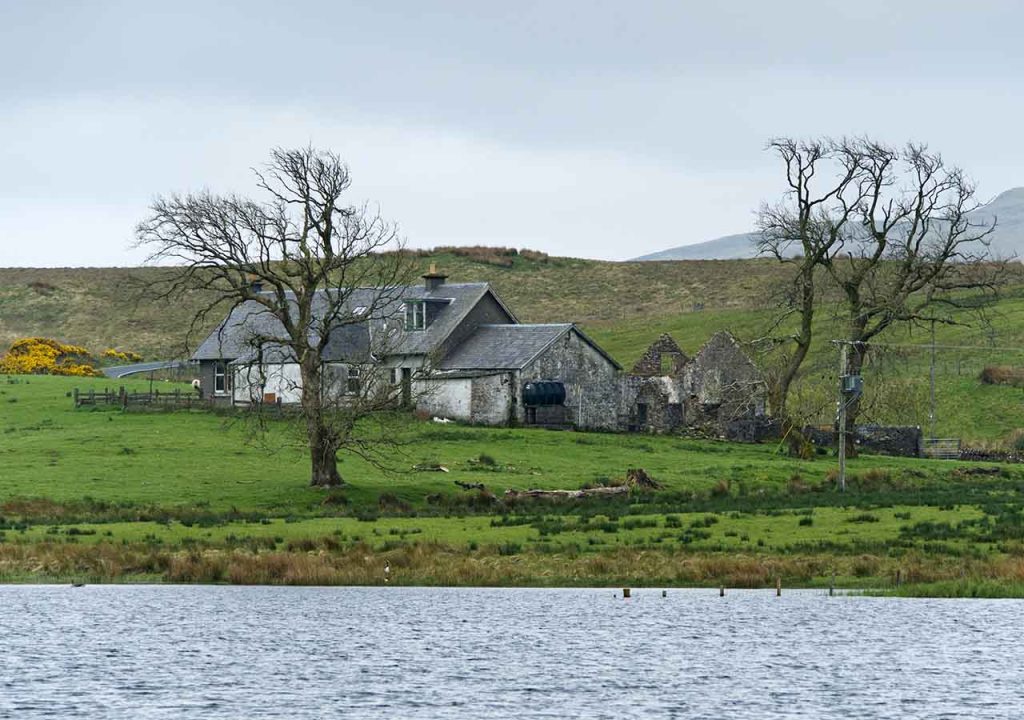 A home near water in the countryside in winter.