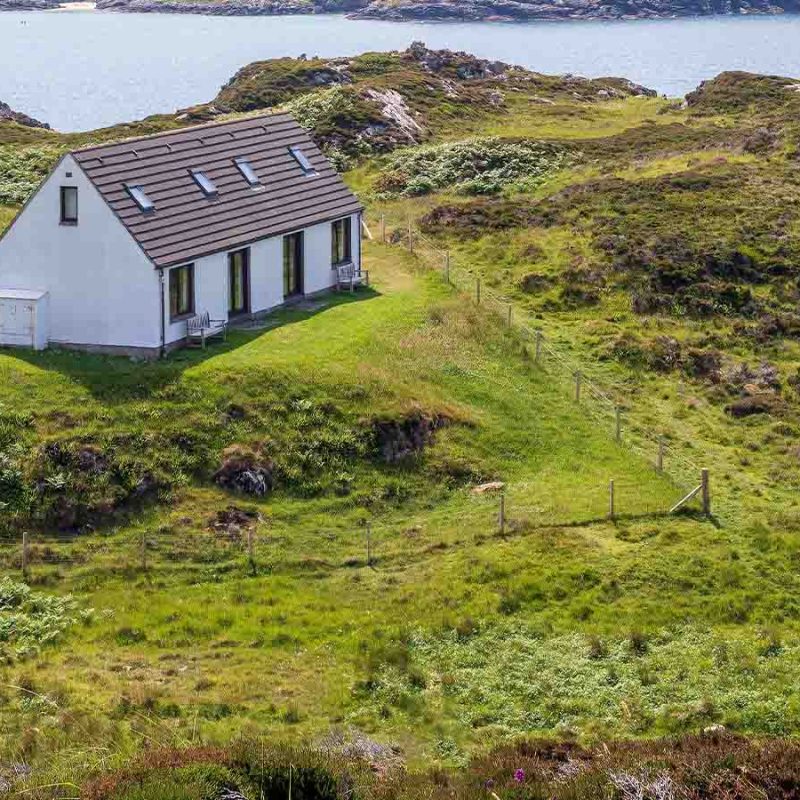 A house away from other buildings near the sea.