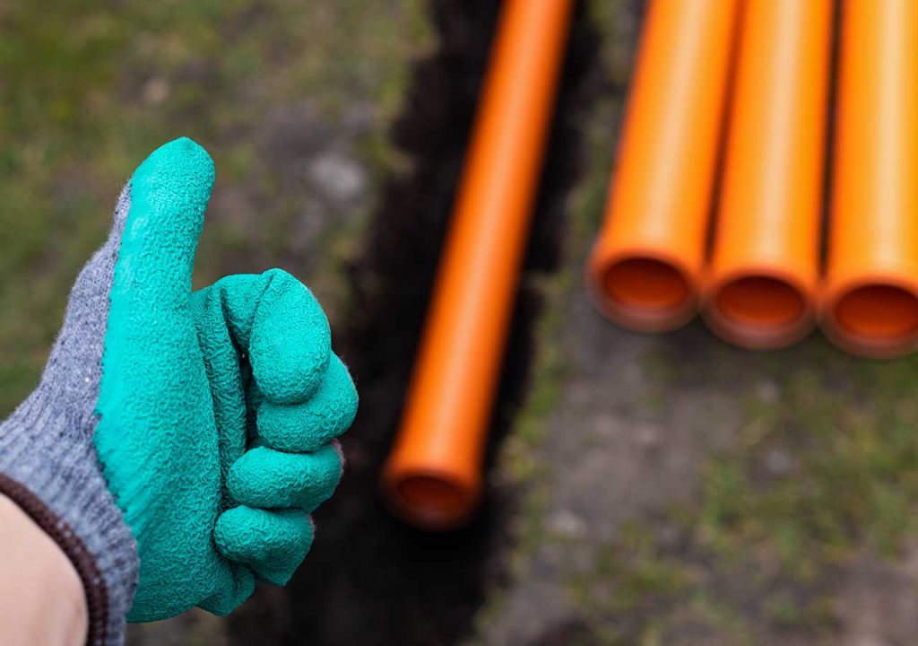 A thumbs up in front of some water pipes.