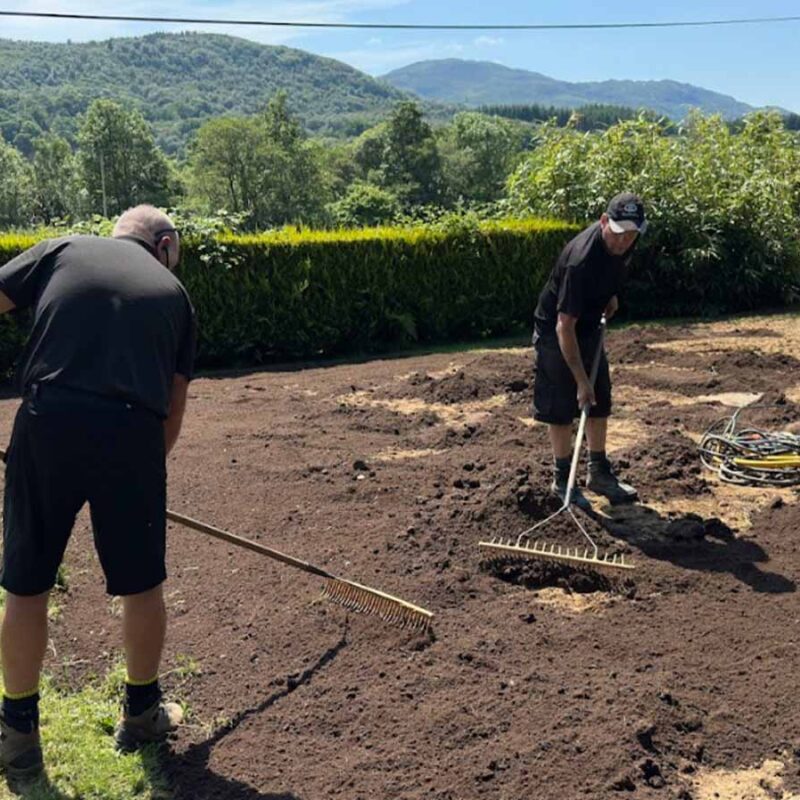 Two people working on the ground in Scotland.