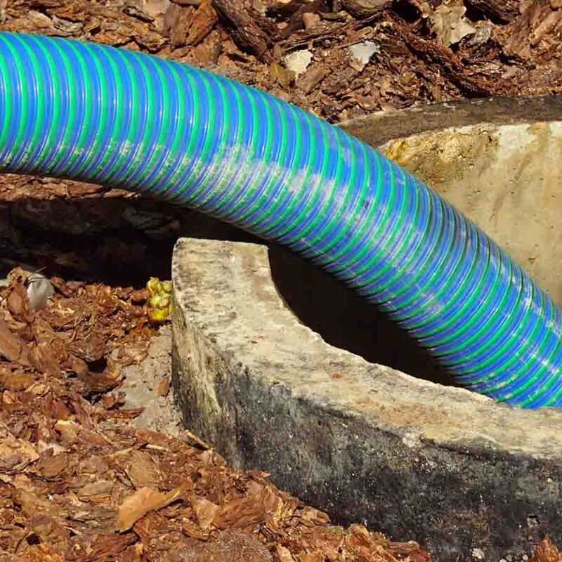 A pipe emptying a septic tank.